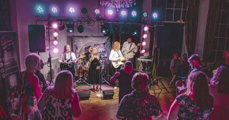 Everything In-Between party band playing in a hall